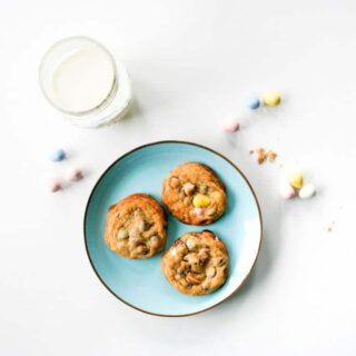 Blue Plate of Cadbury Mini Egg Chocolate Chip Cookies for Easter with a glass of milk