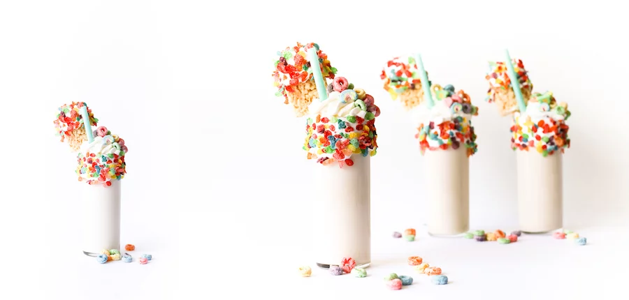 Splurge for breakfast or dessert with this cereal milk milkshake made with cereal-soaked milk, rice krispies treats, and a lot of marshmallow fluff! // Salty Canary 