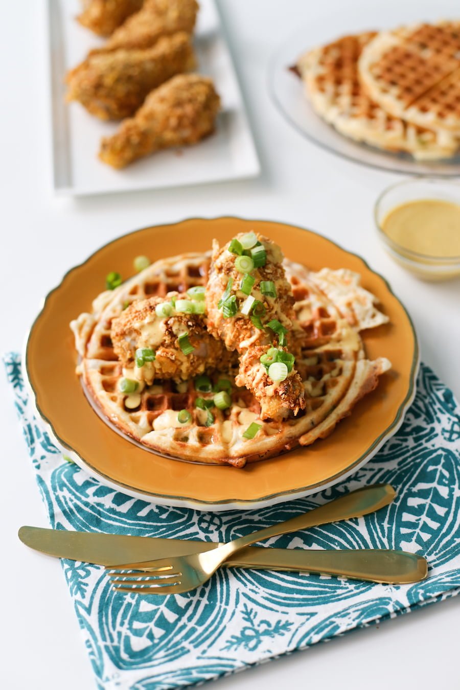 Try this fake baked fried chicken with savory waffles drizzled with a honey mustard sauce! // saltycanary.com