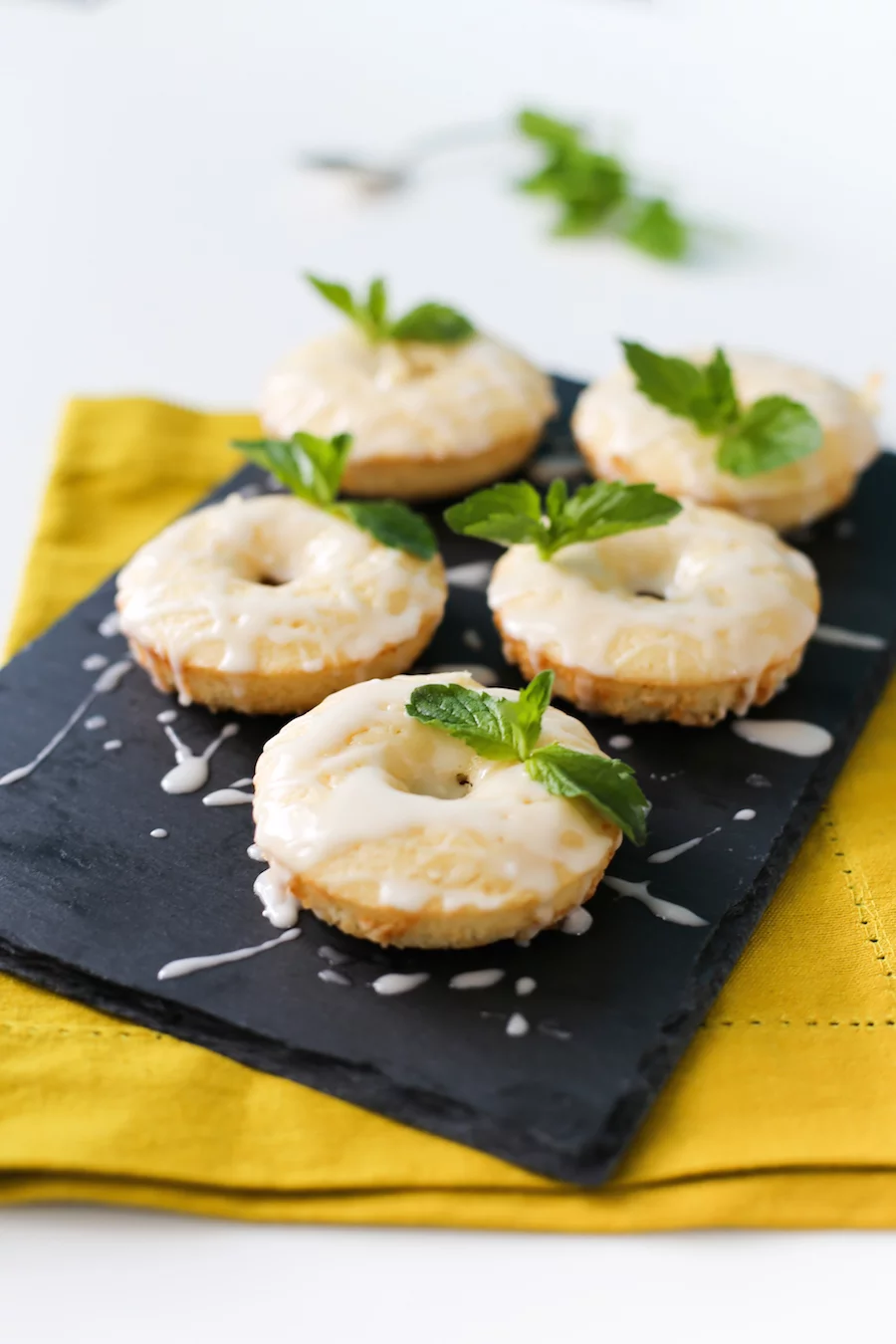 Celebrate the Kentucky Derby at home with these Mint Julep Donuts! A minty lemon baked donut with a delicious bourbon glaze! // saltycanary.com