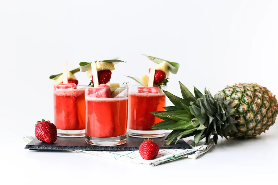 These Tropical Popsicle Mocktails might be my go-to summer treat! They are so good and they are perfect for serving at a party whether it's a pool party, tiki party, or just on a hot Saturday afternoon! // saltycanary.com