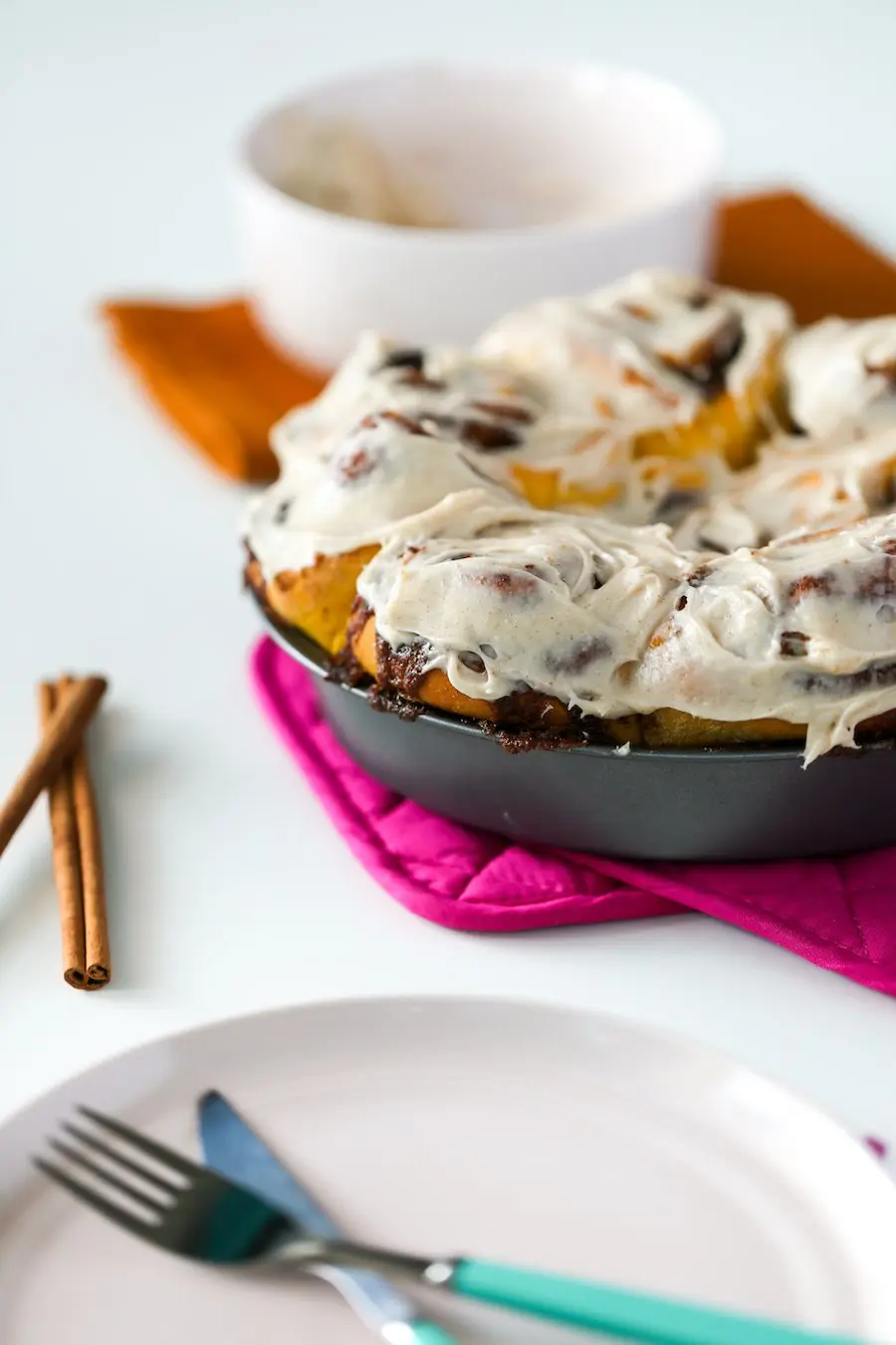 Pan of frosted Pumpkin Spice Cinnamon Rolls