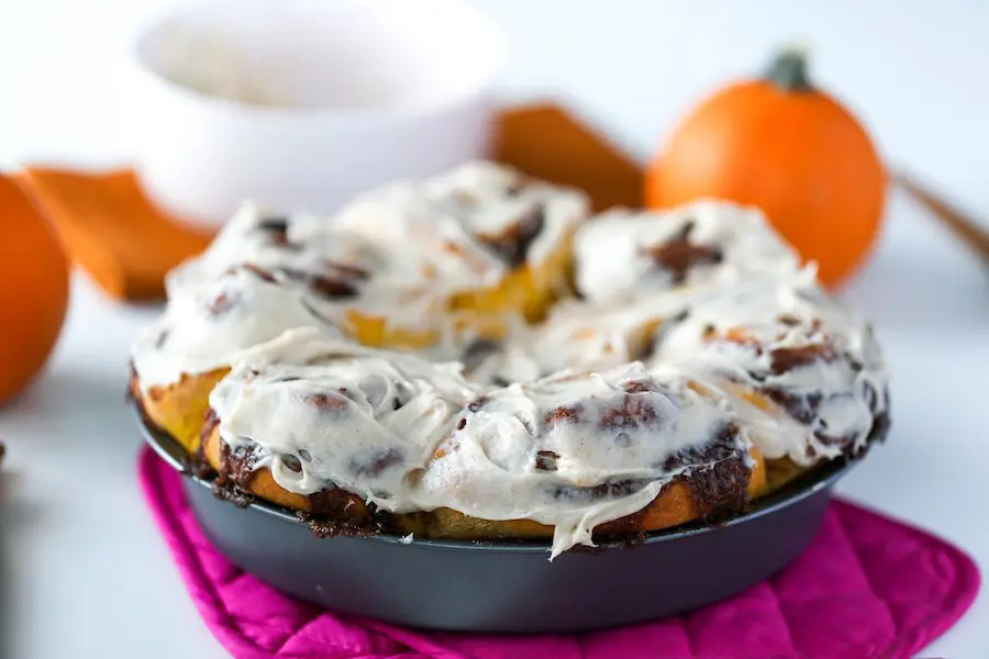 Pumpkin Spice Cinnamon Rolls frosted with a Cinnamon Cream Cheese Frosting