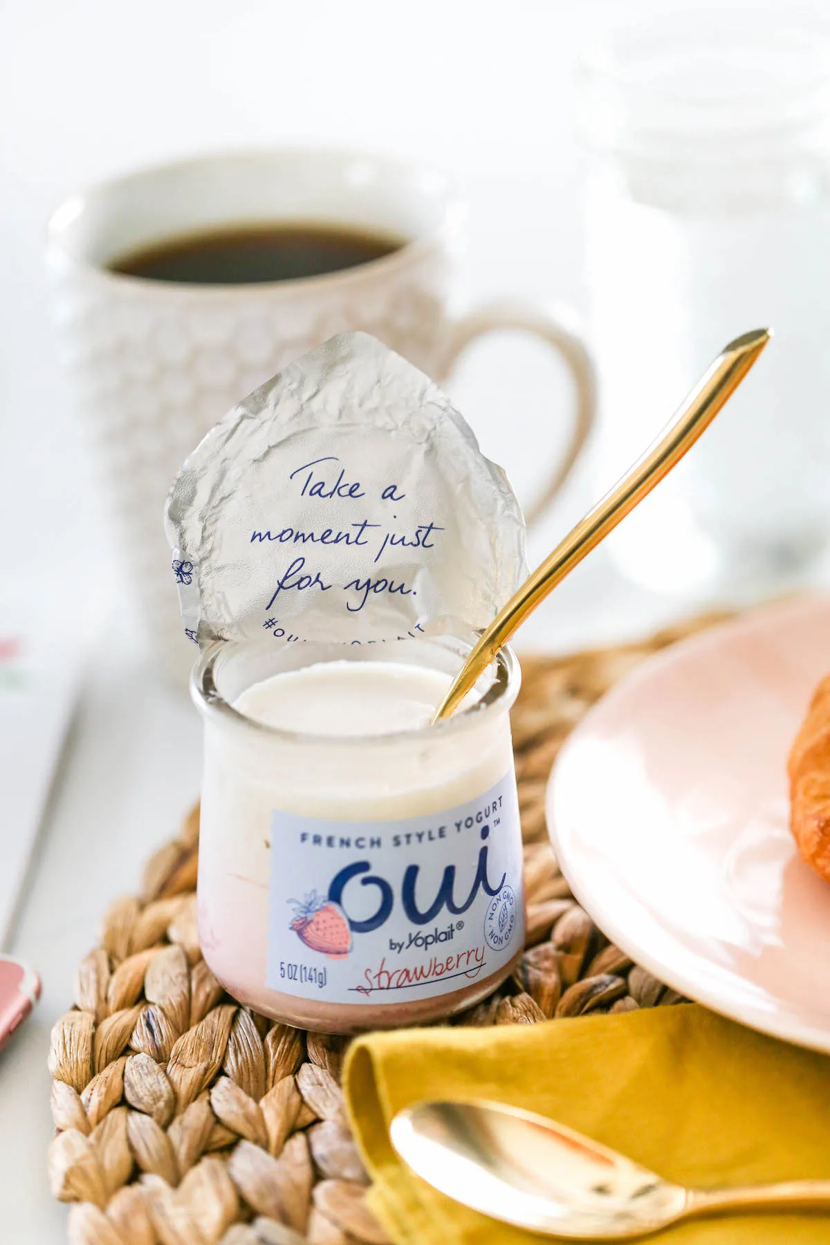 Open bottle of yogurt. The lid has "Take a moment just for yourself" written on it.