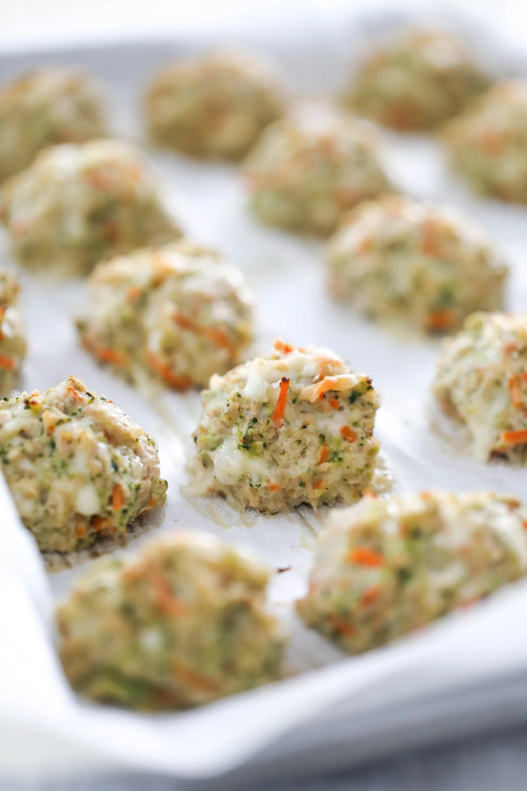 Cooked chicken meatballs on a baking sheet