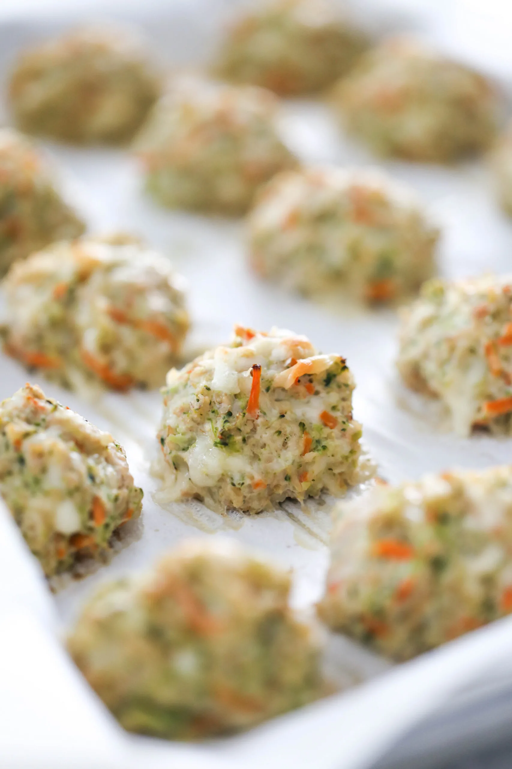 Cooked chicken meatballs on a baking sheet