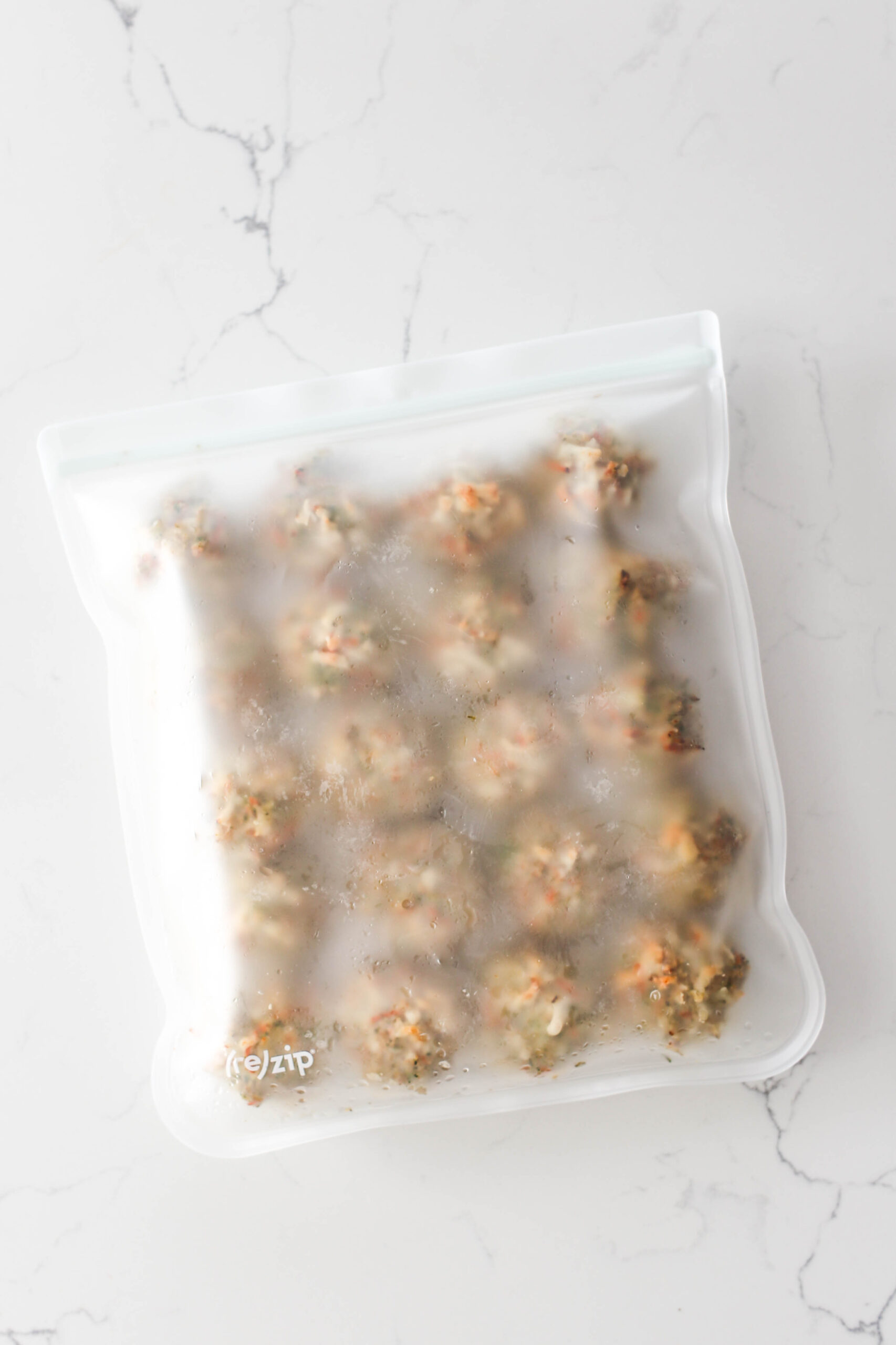 Overhead view of 20 chicken meatballs in a freezer safe bag